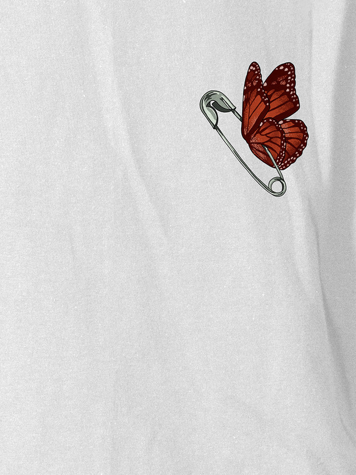 A close-up of a white printed t-shirt by useless treasures. Print of an illustrated ​butterfly with a safety pin body