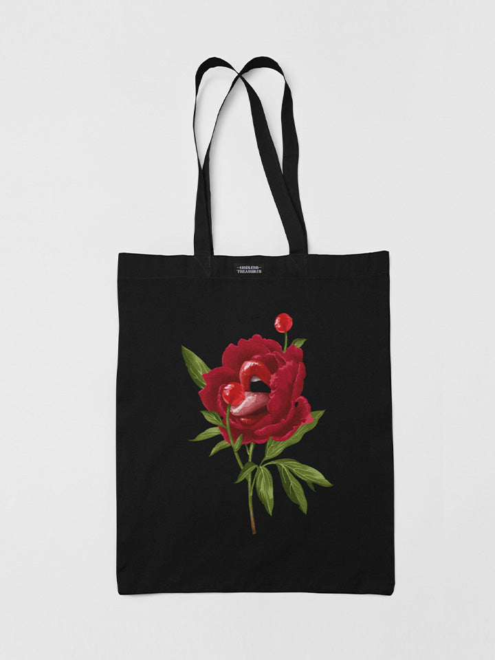 Printed black tote bag. Organic cotton shopping bag printed with useless treasures artwork. A beautiful red rose licking a red candy lolly pop 