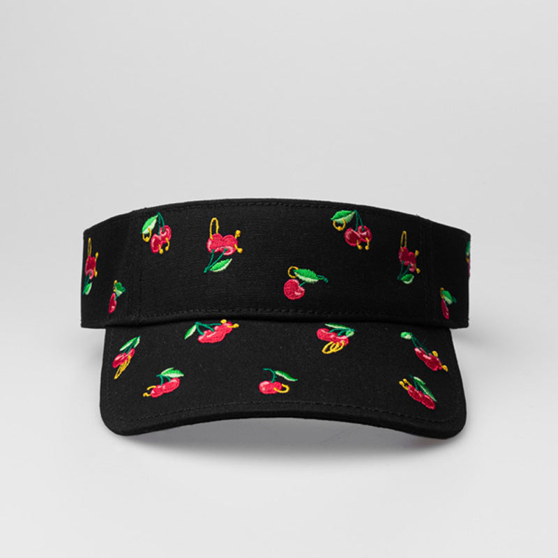 A black On & Off x Useless Treasures Visor hat with small embroideries of cherries with piercings and earrings; on the back to the hat is also a black label of On& Off logo- designed by useless treasures.