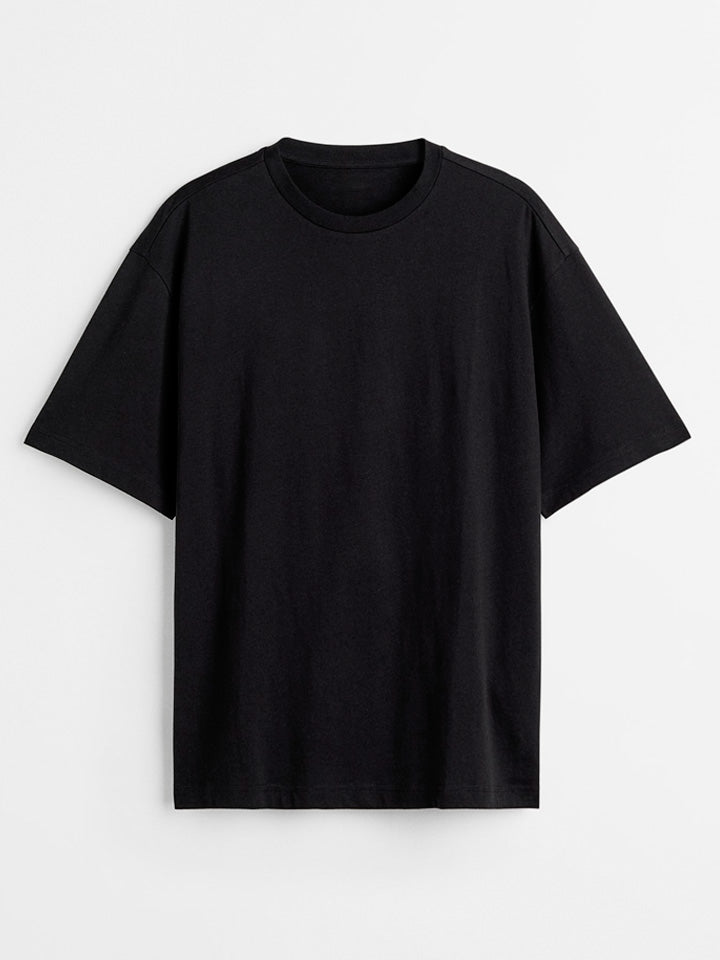 ​A front view to a blank organic oversize black t-shirt from the useless treasures brand. 