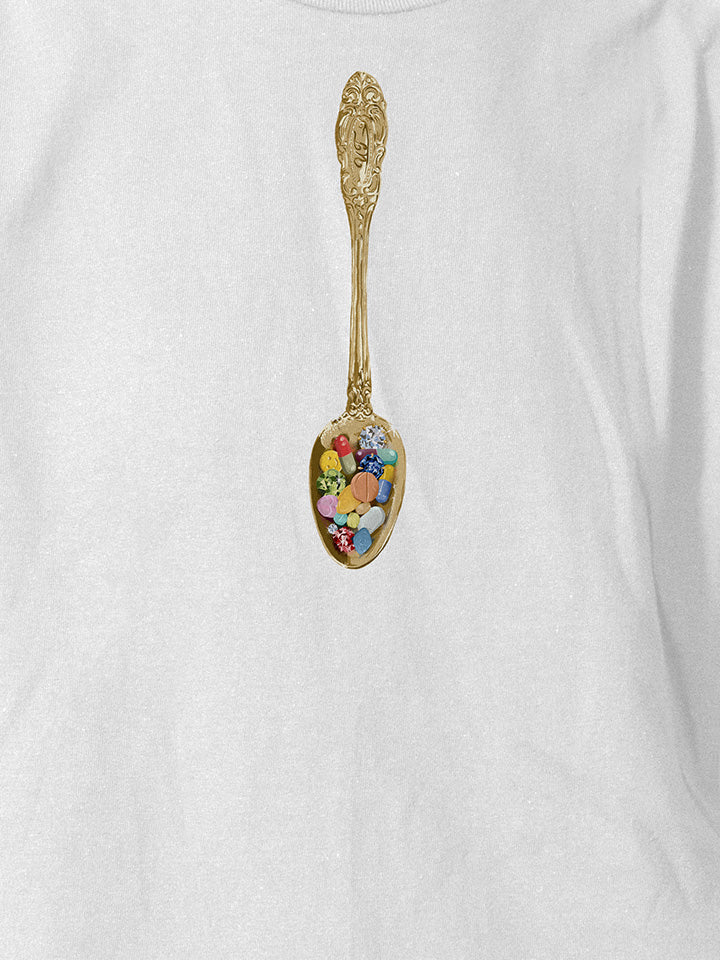 A close-up of a white printed t-shirt by useless treasures. Print of an illustrated golden spoon filled with pills and gems. 
