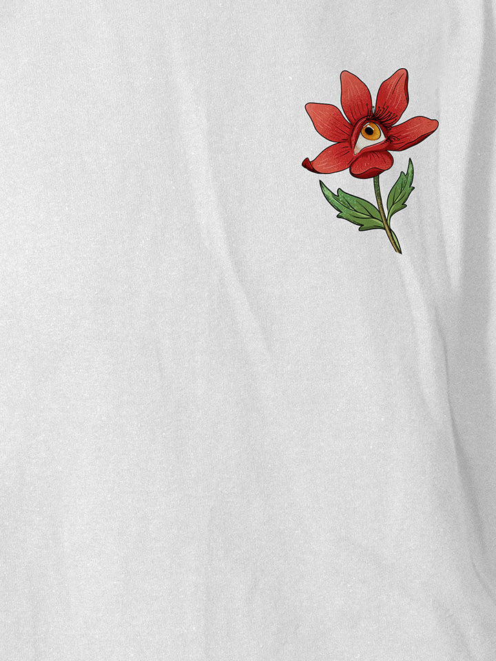  A close-up of a white printed t-shirt by useless treasures. Print of an illustrated red flower with a yellow eye. 