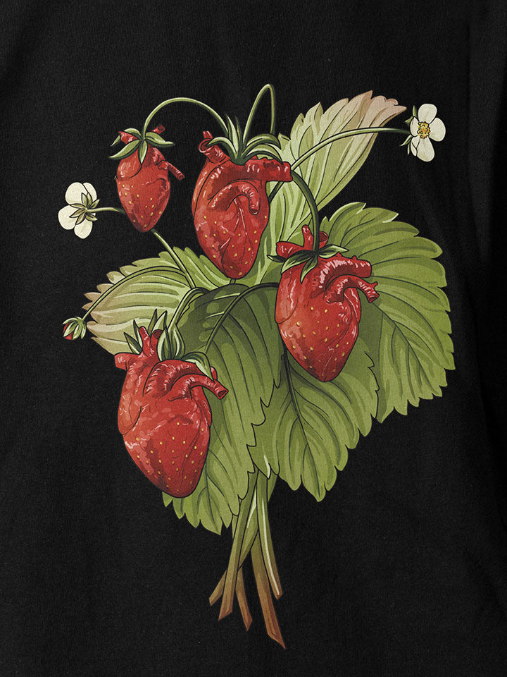  A close-up of a black printed t-shirt by useless treasures. Print of an illustration of a strawberry bouquet shaped like a human heart.  