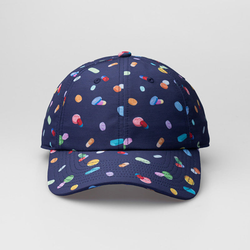 A blue On & Off x Useless Treasures dad hat with Digital prints of drugs pills and MDMA pills; on one side of the hat is also a black label of On& Off logo- designed by useless treasures.