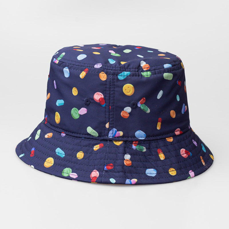 A blue On & Off x Useless Treasures bucket hat with Digital prints of drugs pills and MDMA pills; on one side of the hat is also a black label of On& Off logo- designed by useless treasures.