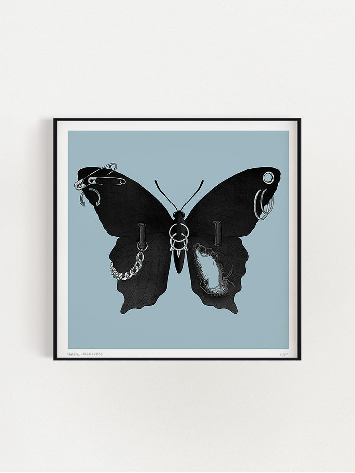 An illustration of a black Butterfly with wings made of black jeans with a tear in one wing and a silver chain on the other wings connected to the jeans belt hops. It also has earrings like safety pins and piercing on top of a light blue background- Art by useless treasures.