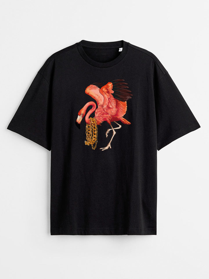 A Black oversize printed T-shirt. Short sleeve Shirt with a print called "heavyweight" of bright pink flamingo wearing a log of gold chains on its neck. Illustration by useless treasures. Organic cotton, loose fit.